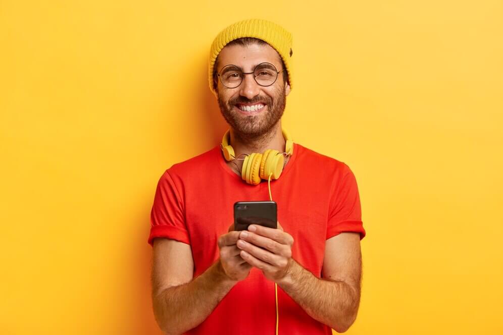 attractive-cheerful-guy-with-bristle-wears-bright-hat-red-t-shirt_273609-27714